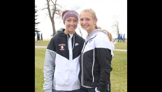 Jaycie Byrne, left, and Jalyssa Blazek smile for the camera before the Class 1A State Cross Country Meet.