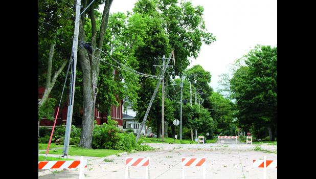 The intersection of 2nd Street East and 3rd Ave East was blocked off Thursday morning after a tree fell on power lines Wednesday night.
