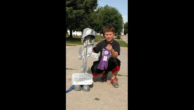 Kole Balvanz with his People’s Choice and blue ribbons he received for the Battlefield Cross duct tape project he created in memory of his friend, Lindsay Stupp.
