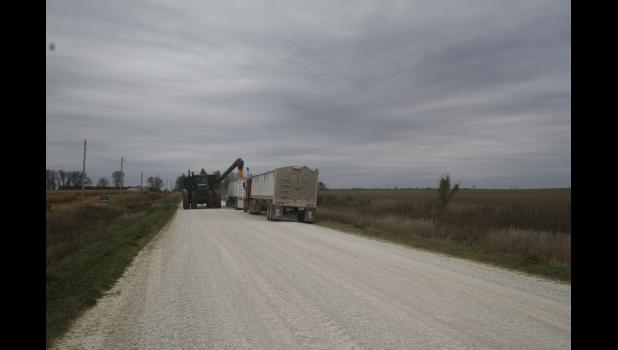 Harvesting 850 acres of corn for the John Mahr (inset) family worked like an assembly line as combines, carts and semis loaded quickly on Sunday and Monday
