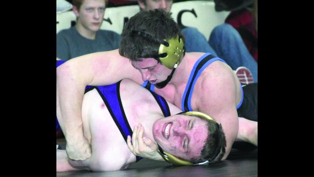 Trae Pecinovsky, top, attempts to pin Bryan Graves of Oelwein during the finals at 152 Saturday at the sectional tourney.