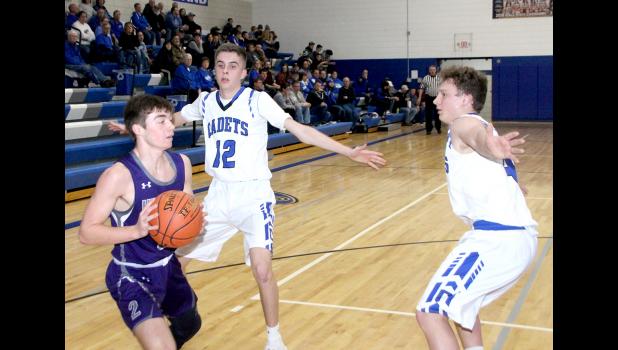 Cadet defenders Reid Wiley (12) and Bryer Thompson try to trap an Oelwein player.
