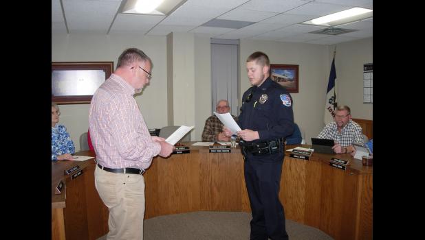 Keefe Williams takes the Oath of Office as Police Officer for the City of Cresco with Mayor Mark Bohle, left.