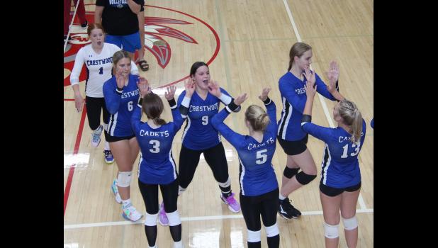 Members of the Crestwood volleyball team celebrate their win over Central.