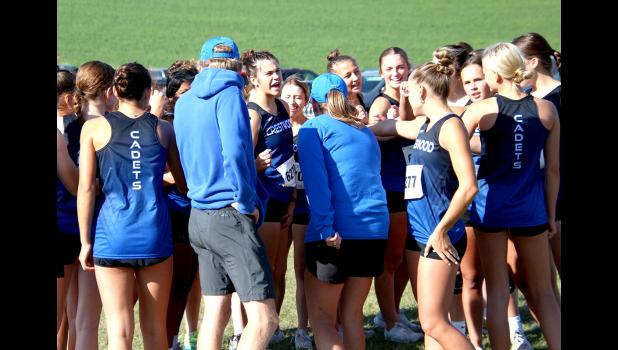 Coaches Jon Berland and Karen Steffen give the girls' team a pep talk.